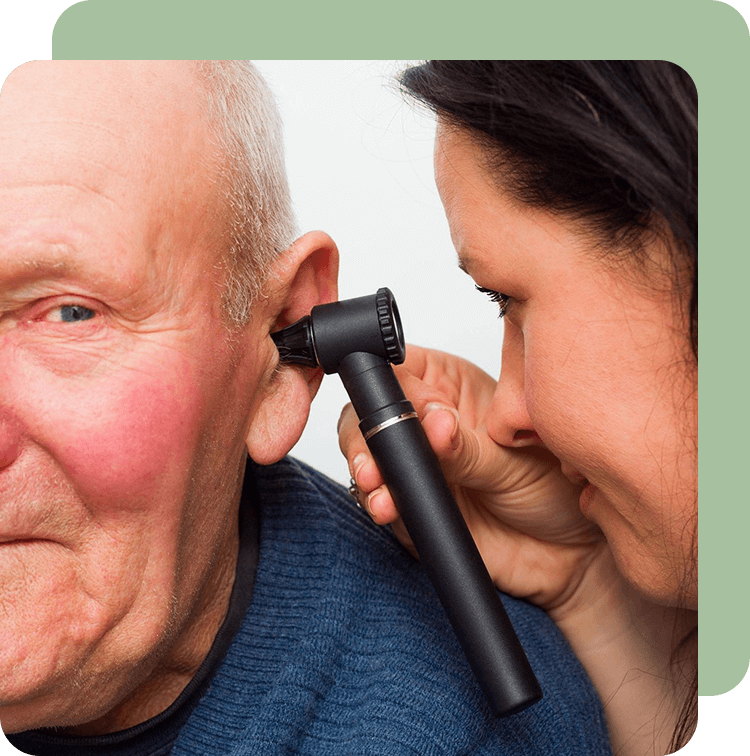 A woman is putting a microphone to an older man 's ear.